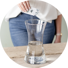 Woman filling vase with water and food